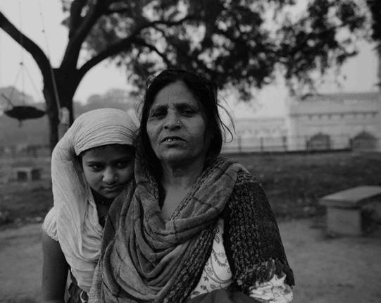 Migrant mother and daughter on the grounds of the Tile Wala Masjid Migrant mother and daughter on the grounds of the Tile Wala Masjid